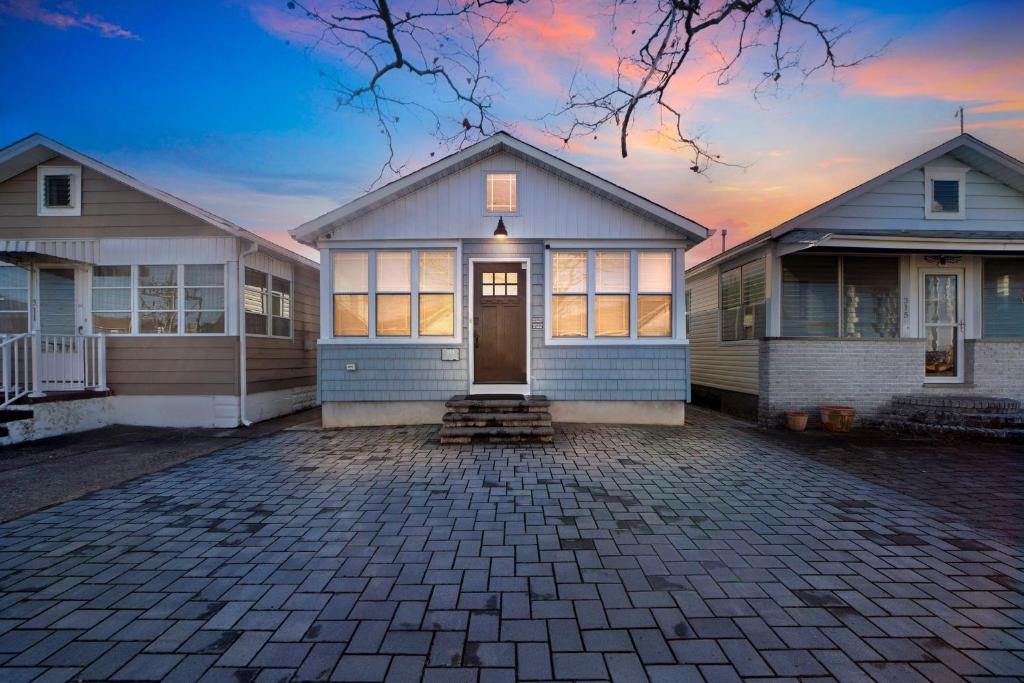 a house with a driveway in front of it at Cozy 3-BR Retreat, Four Blocks to Beach & Boardwalk home in Seaside Heights