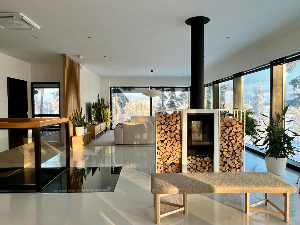 a living room with a stack of fire wood at Unique lakehouse Villa Valo in Hollola
