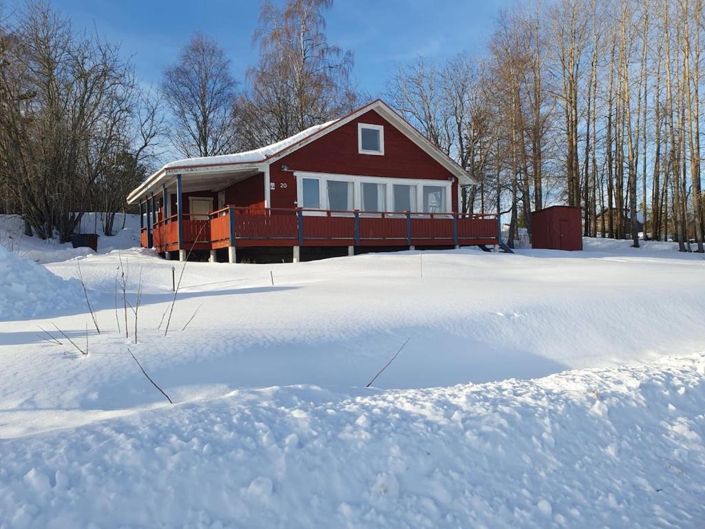 a red house with snow in front of it at The view of Skattungbyn in Skattungbyn