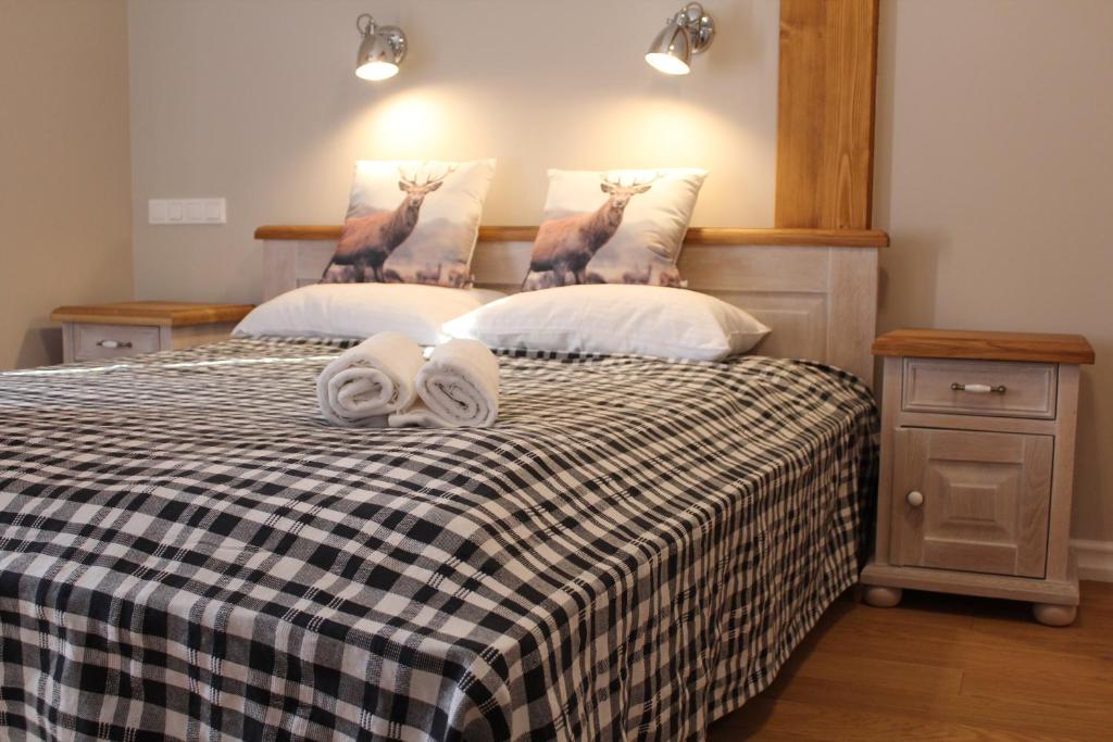 a bedroom with two beds with towels on the bed at Villa Rustica in Polańczyk