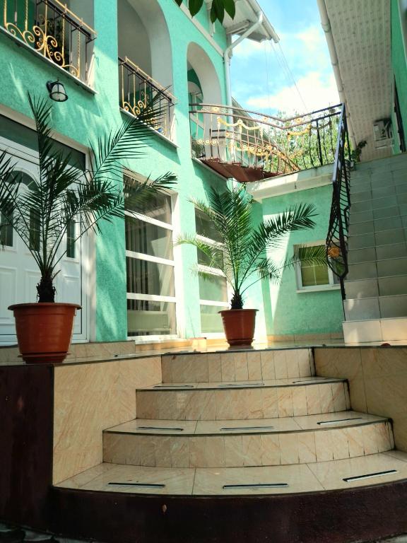a building with potted plants in front of a building at Guest House Sirius in Chişinău