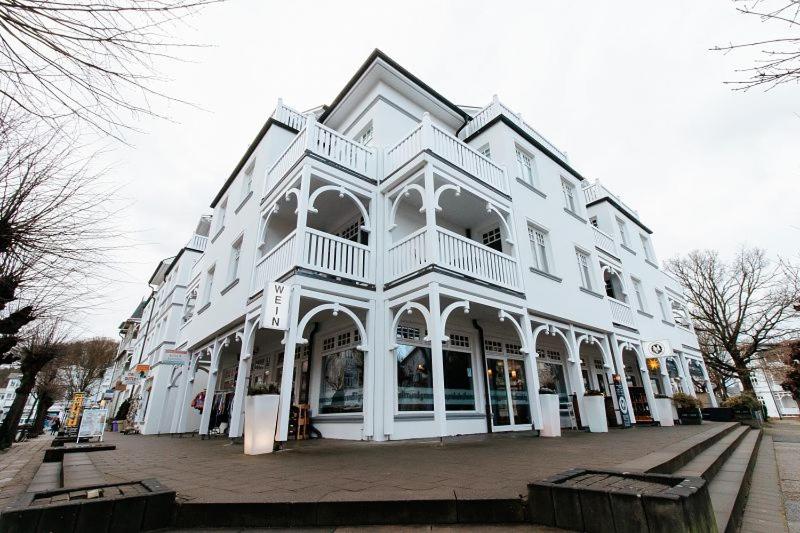 a large white building on a city street at Villa Laetitia Whg 24 in Binz