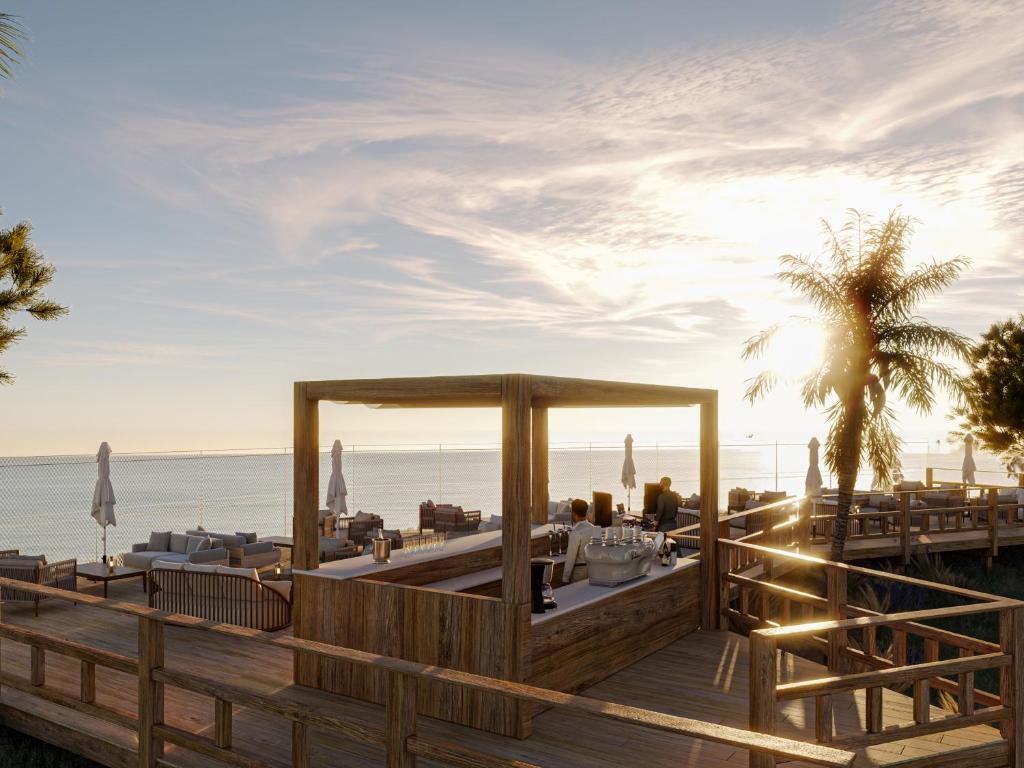 a restaurant on the beach with the ocean in the background at PortoBay Blue Ocean in Albufeira