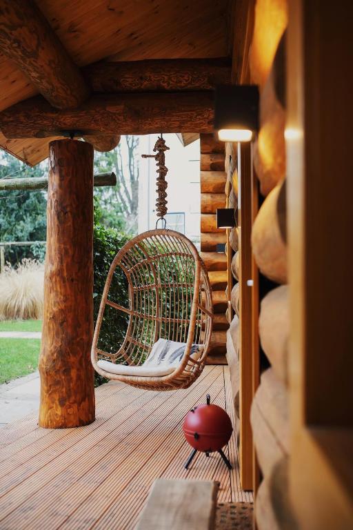 a porch with a hammock on a wooden deck at De Stamboom in Hardinxveld-Giessendam