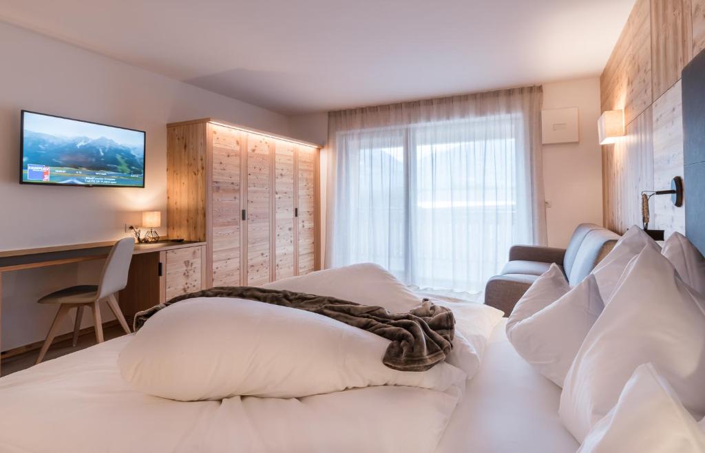 Postel nebo postele na pokoji v ubytování Hotel B&B Feldmessner