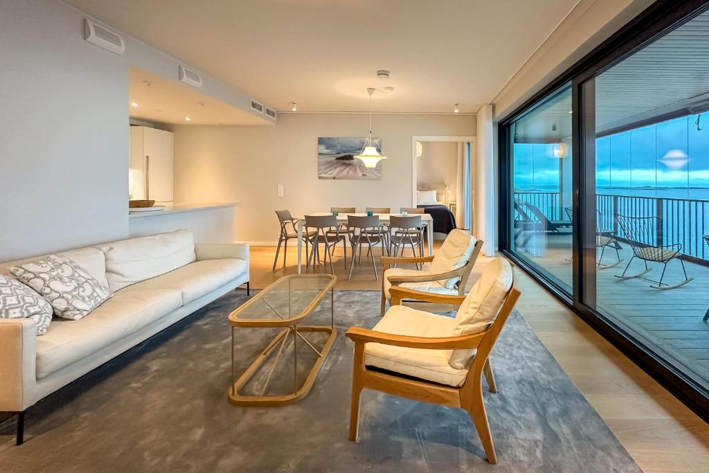 a living room with a couch and chairs and a table at Pearl Suite in Kuningatarranta Hanko in Hanko