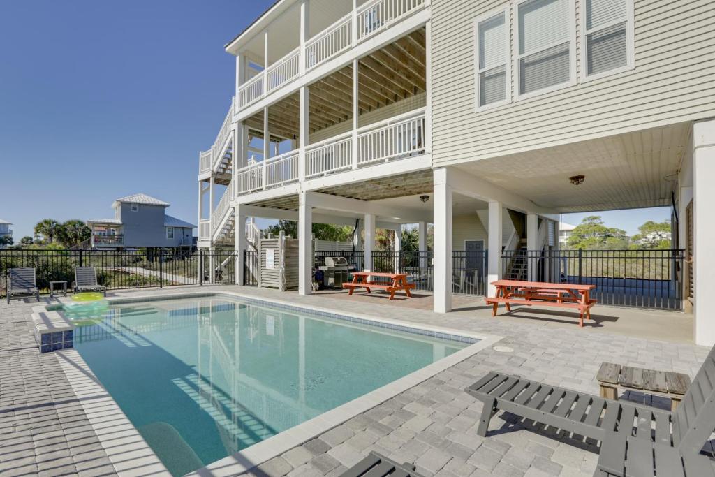 a swimming pool in front of a house at Beachfront Paradise with Pool on St George Island! in St. George Island