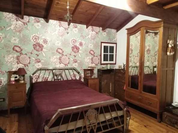 a bedroom with a bed and a wall with flowers at Khaleesi home in Miramar