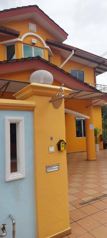 a yellow and blue house with a door at Skudai close to JB Town Corner House in Johor Bahru