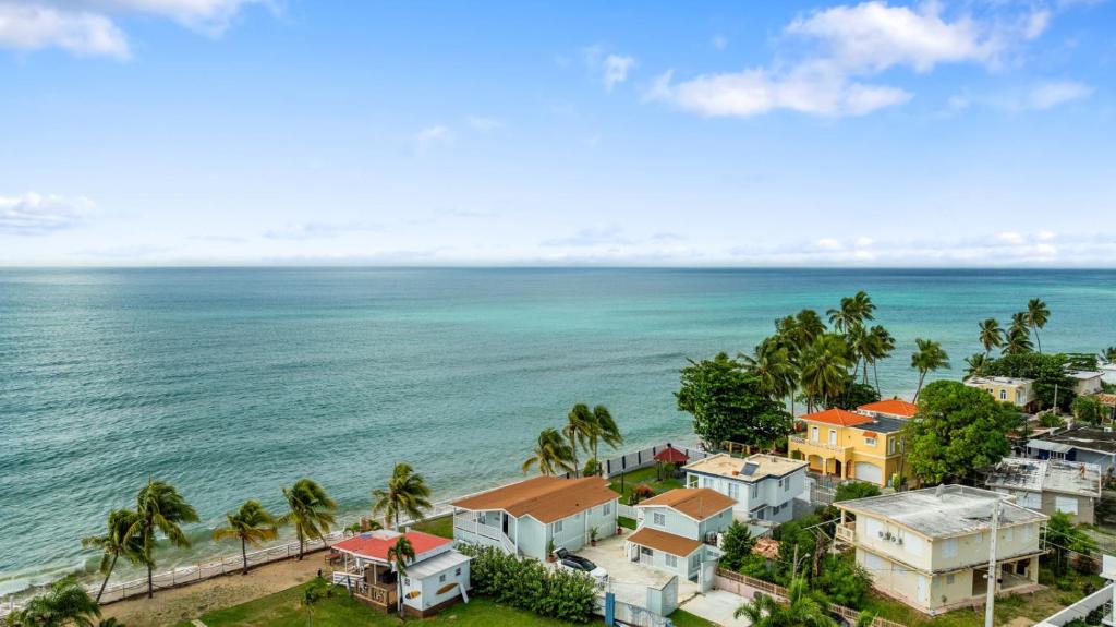 an aerial view of a resort and the ocean at Danielas Beachfront Apartment in Rincon