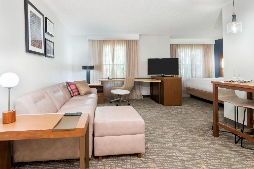 a hotel room with a couch and a bed at Residence Inn by Marriott Sarasota Bradenton in Sarasota