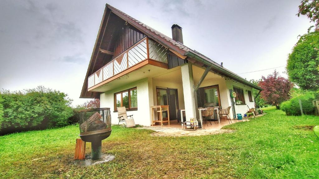 a house on a field with a statue in front of it at Traumhaus im Grünen in Calw