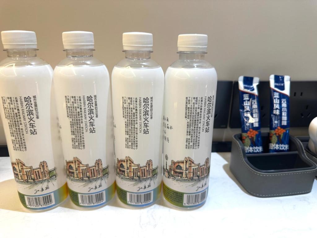a group of four bottles of milk on a table at Purple Stone High-End Designer Loft in Harbin