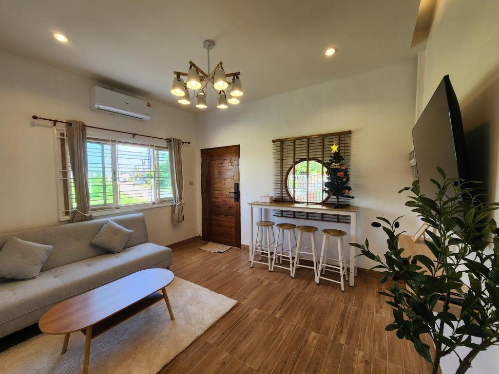 a living room with a couch and a table at 19 House in Ban Khlong Pleo