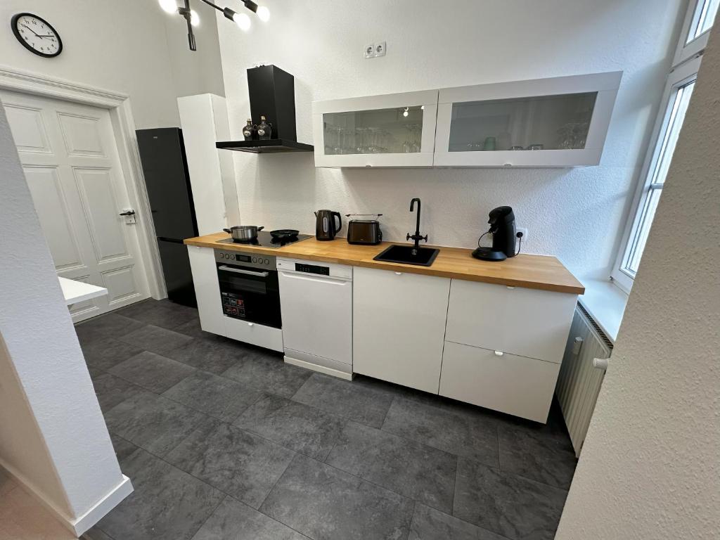 a kitchen with white cabinets and a counter top at ElbPerle Meißen-Altstadt WLAN Parken WOHLFÜHLEN in Meißen