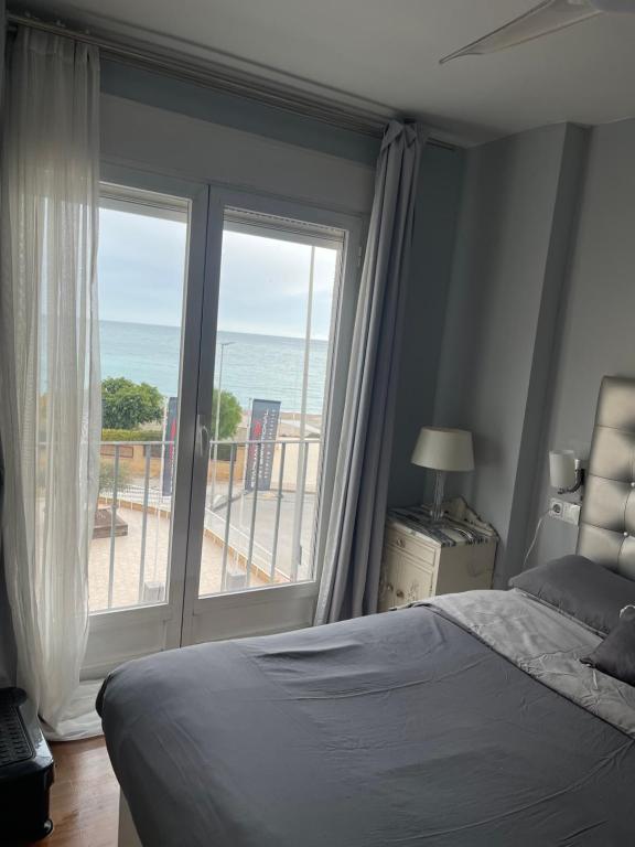 a bedroom with a bed and a view of the ocean at Altea Beach in Altea