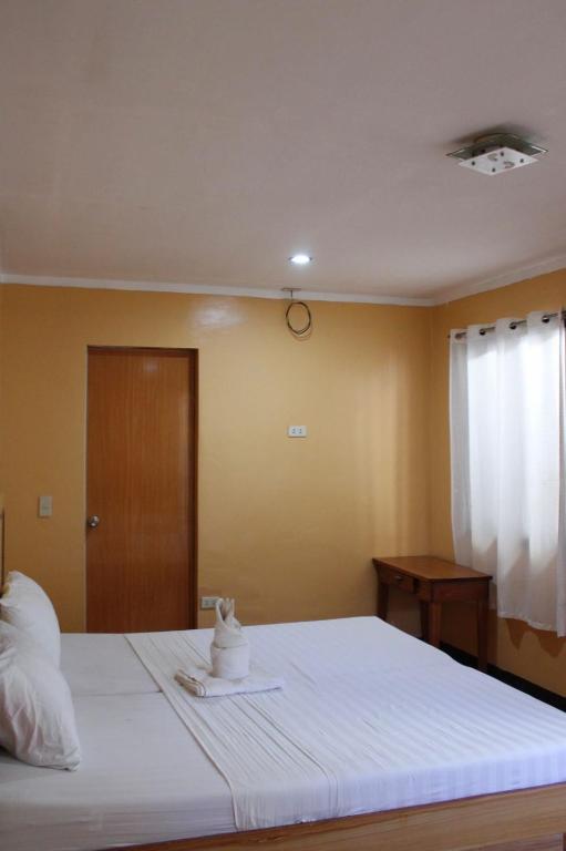 Postel nebo postele na pokoji v ubytování Agustin El Nido Inn