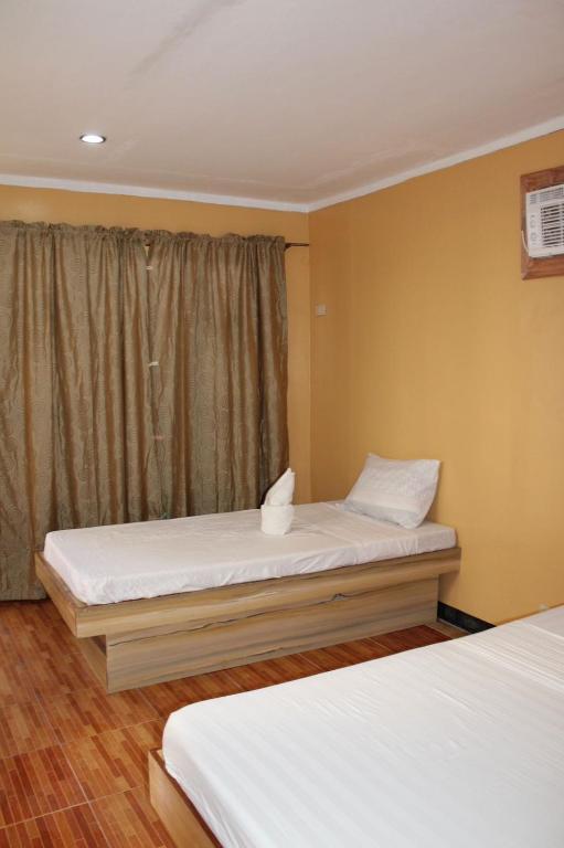 Postel nebo postele na pokoji v ubytování Agustin El Nido Inn