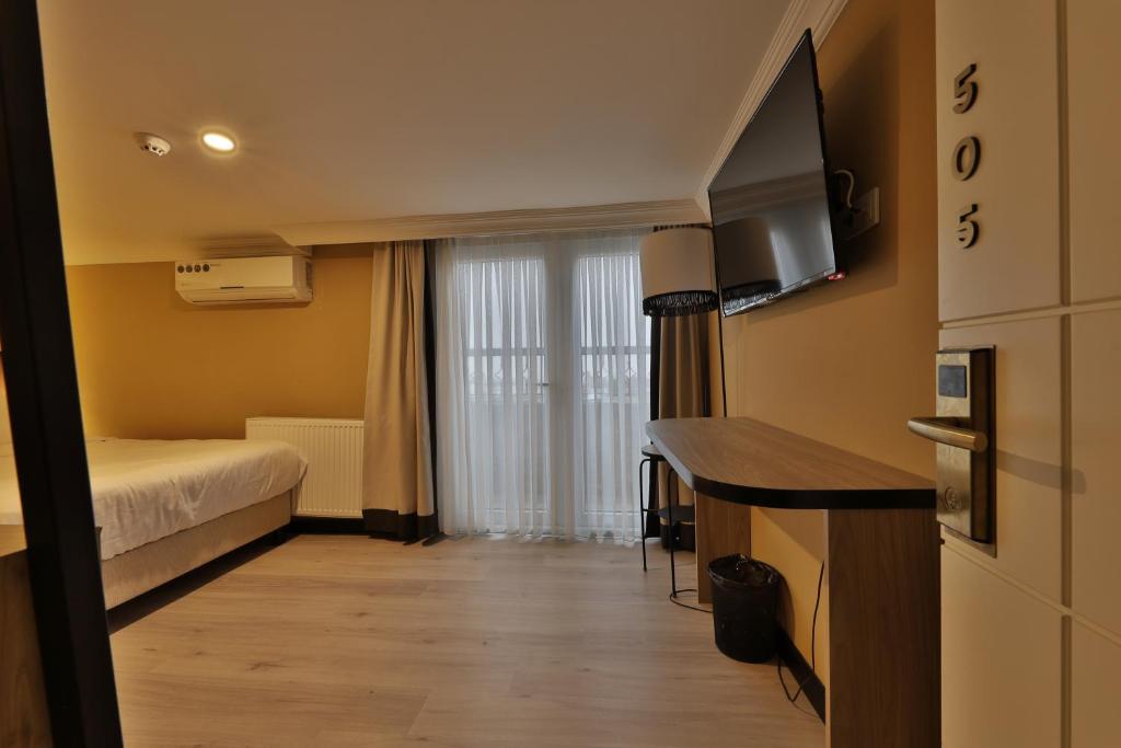 A bed or beds in a room at EA Exclusive Hotel