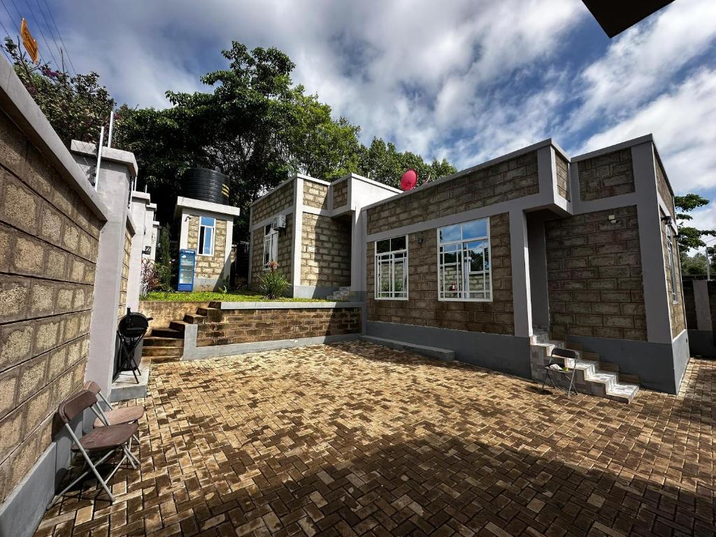 a brick house with a brick driveway at chamber 206 in Arusha
