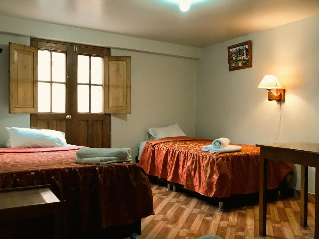 Postel nebo postele na pokoji v ubytování Nafis Casona Apu Linli Pisac