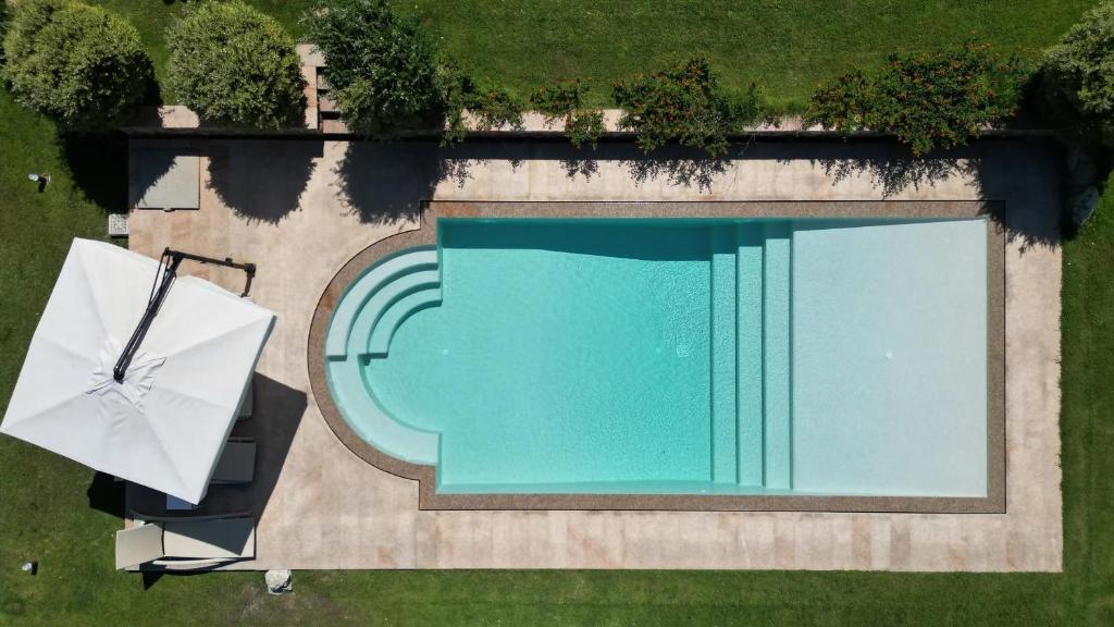 an overhead view of a swimming pool with an umbrella at Villa Supramonte luxury villa CIN IT09006CR in Marazzino
