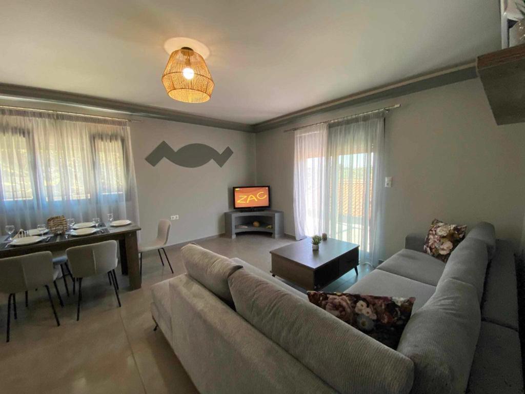 a living room with a couch and a table at Stavros luxury apartment in Skiathos Town