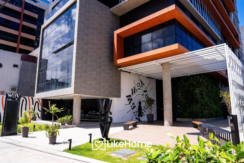 a building with a bench in front of it at Edifício Way Tambaú in Tambaú
