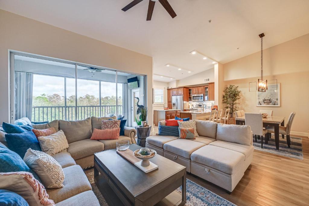 a living room with a couch and a table at Elegant Naples Condo with Golf View and Community Pool in Naples