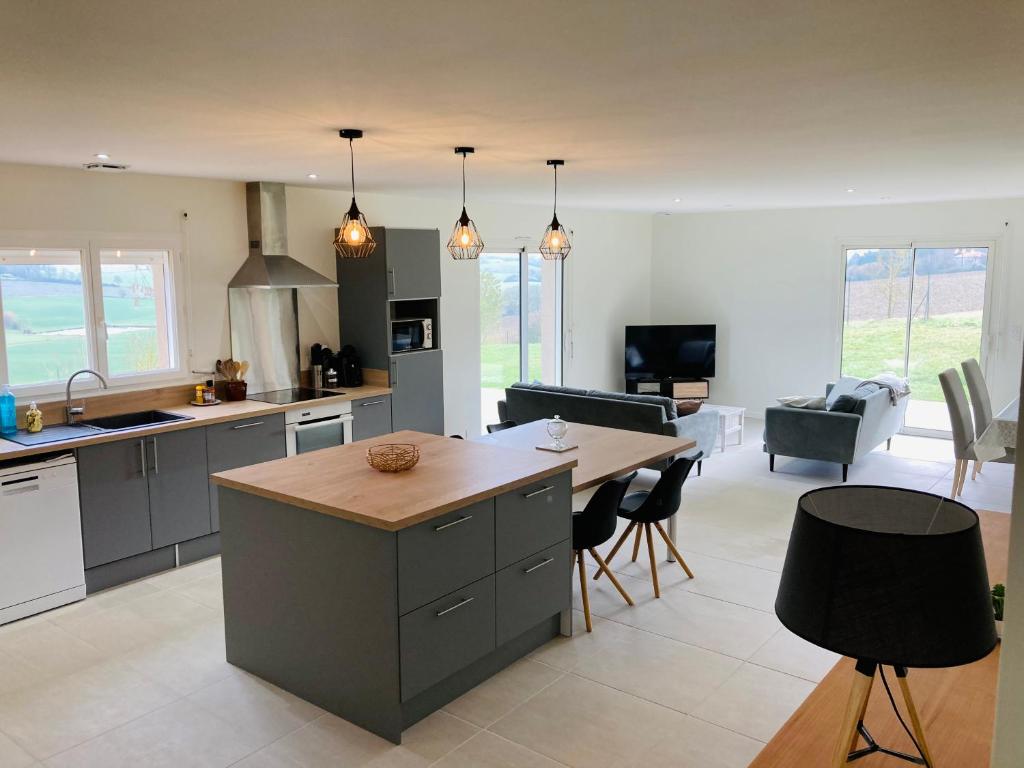 une cuisine et un salon avec une table et des chaises dans l'établissement NOUVEAUTE Maison avec vue dominante sur la campagne, à Lamontjoie