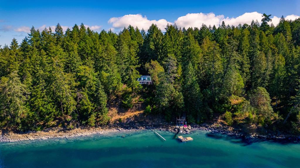 an aerial view of a house on the shore of a lake at Thetis Island Get Away Cottage in North Galiano