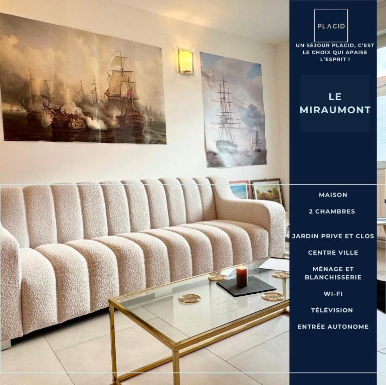 a living room with a white couch and a glass table at Le Miraumont - Centre - Jardin in Calais