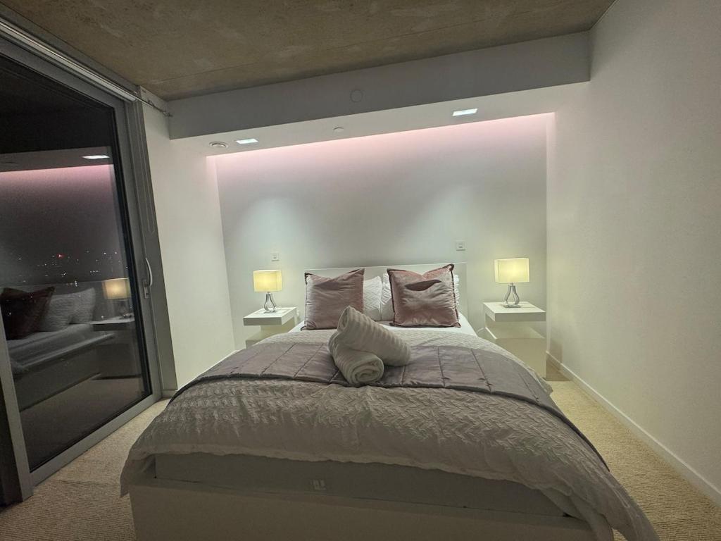 a bedroom with a large bed with two lamps at Luxury 1 Bedroom Apartment In London with Free parking in London