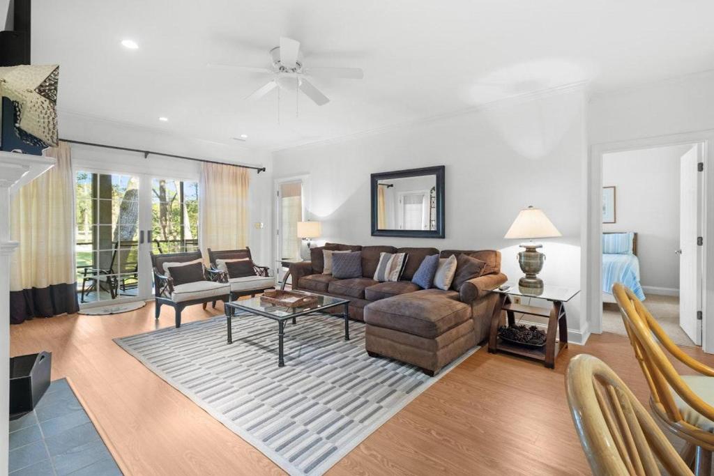 a living room with a couch and a table at Pawleys Plantation Retreat Villa Deluxe Amenities in Pawleys Island