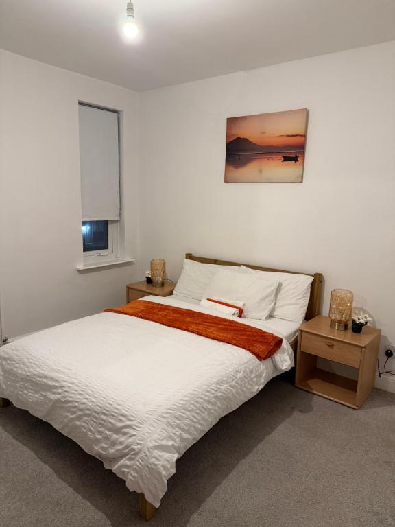 a bedroom with a large white bed and a window at 2 Bedroom House in Nottingham
