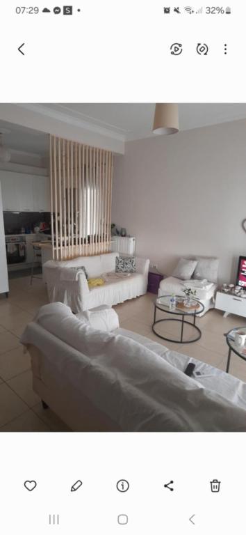 a living room with two white couches and tables at Christi & Paris Nest in Volos