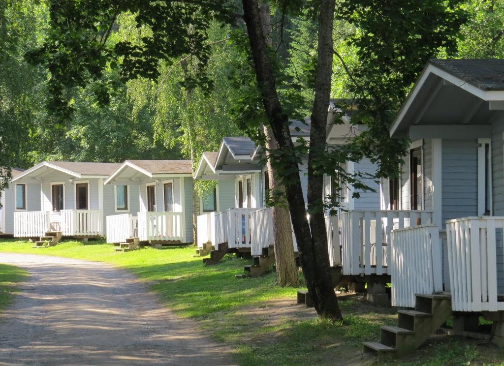 a row of white cottages in a row at Tampere Camping Härmälä in Tampere