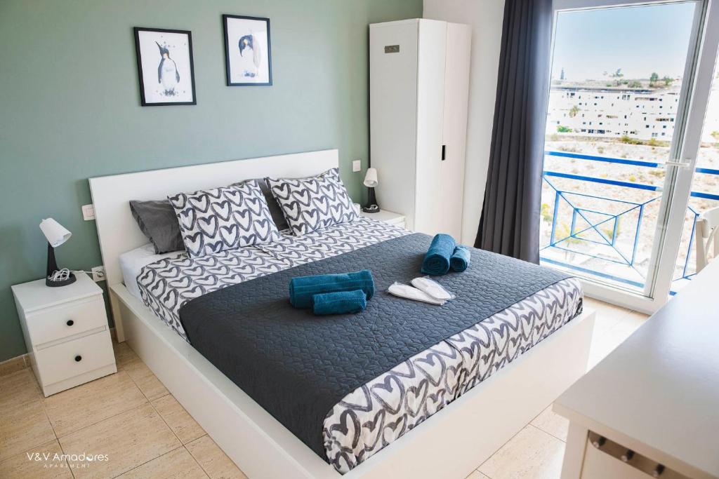 Łóżko lub łóżka w pokoju w obiekcie V&V Amadores Apartment