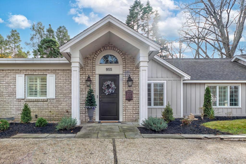 a brick house with a black door at The Gardens - Azalea - Walking distance to Douglas Beach - Private hot tub in Douglas