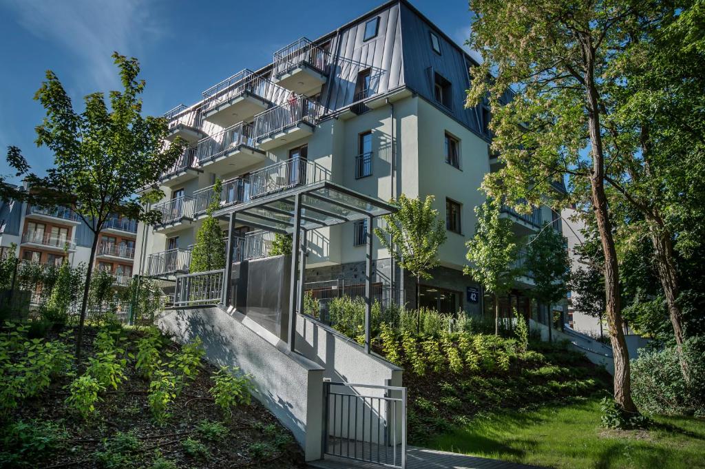 an apartment building with balconies and trees at MariSol in Świnoujście