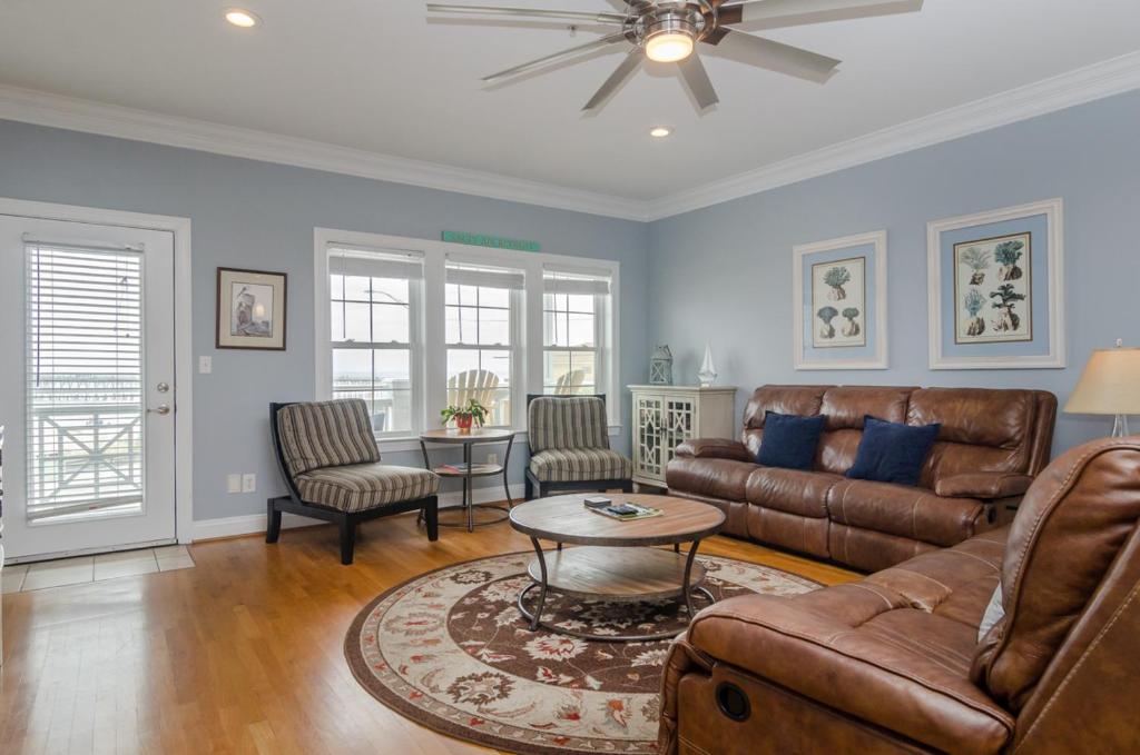 a living room with a couch and a table at The View by Bryant Real Estate in Kure Beach