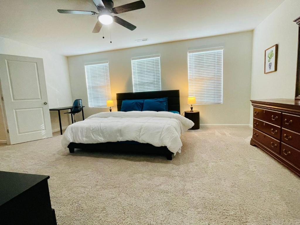 a bedroom with a bed and a ceiling fan at Luxury Living! Peaceful,Comfort and Spacious in Winston-Salem