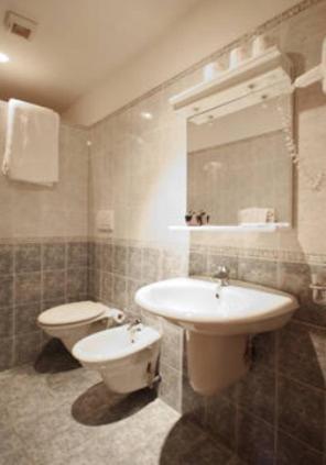 a bathroom with a sink and a toilet at Hotel Villa Flora in Bogliasco