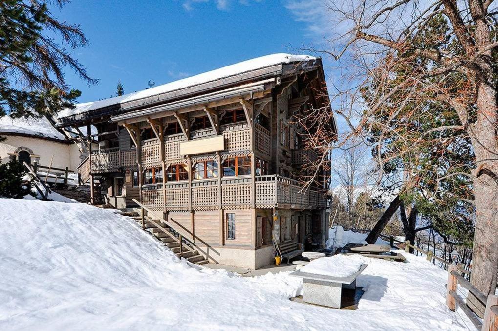 a large wooden building with snow on the ground at Chalet Rosablanche, since 1929 - peace, quiet & tradition in Nendaz