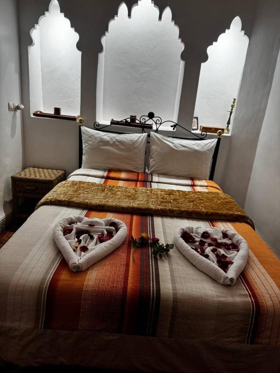 Postel nebo postele na pokoji v ubytování Riad Lwalidin