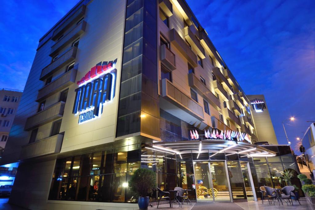 een hotelgebouw met tafels en stoelen ervoor bij Tiara Thermal & SPA Hotel in Bursa