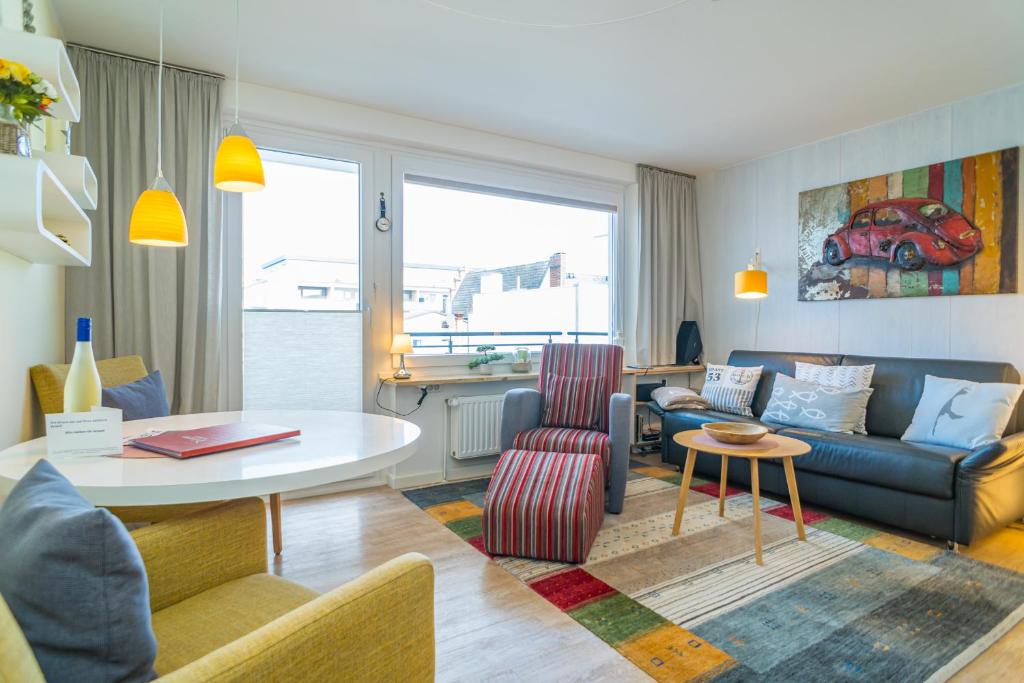 a living room with a couch and a table at Apartmenthaus Dünenburg Dünenburg App 31 in Westerland (Sylt)