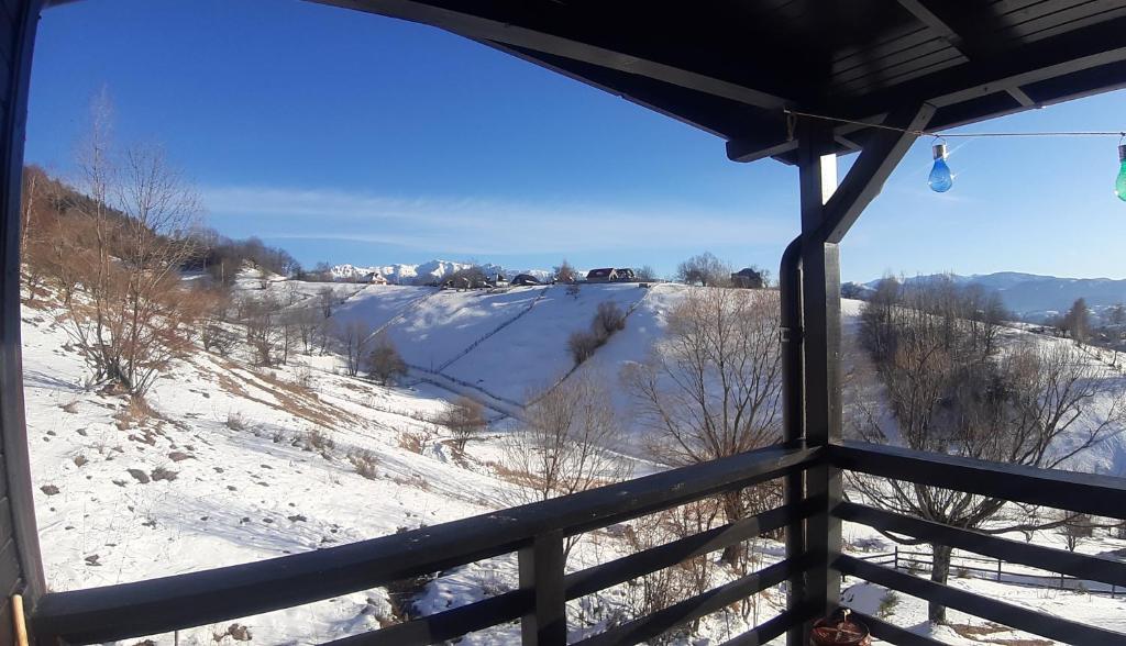 a room with a view of a snow covered hill at Magura Rustic Tiny House in Măgura