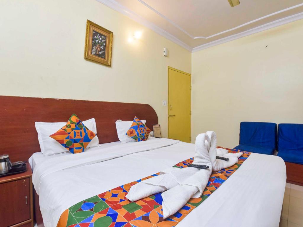 a bedroom with a bed with towels on it at Hotel O Utsav in Jaipur