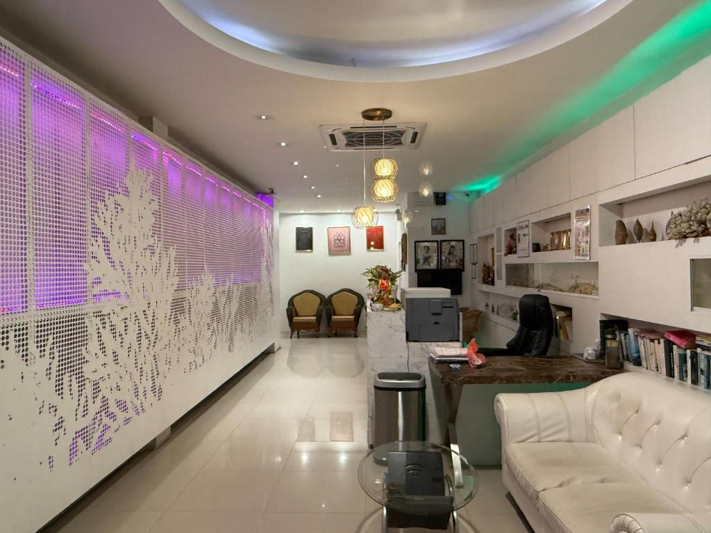 a living room with a wall with purple lights at Coral Inn in Karon Beach